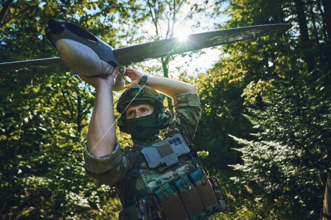 drones soldier holding pre launch drone in forest 676x450 219332